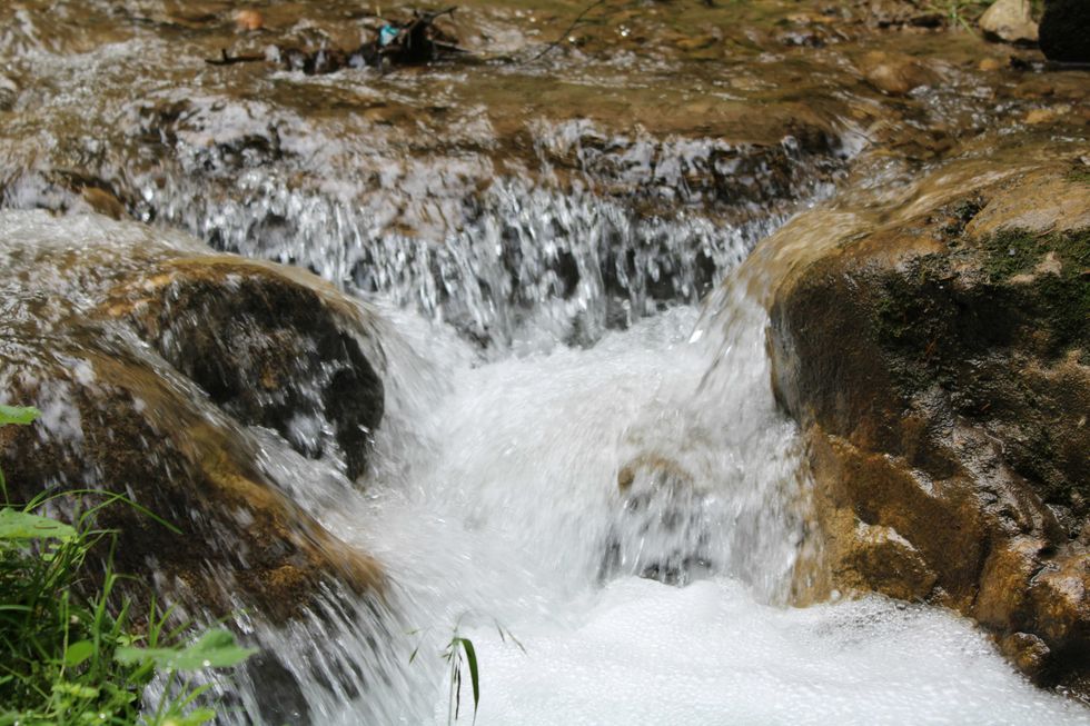 a close up of a small waterfall in a stream
