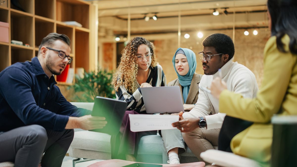 A diverse team collaborating cross-functionally on a product launch