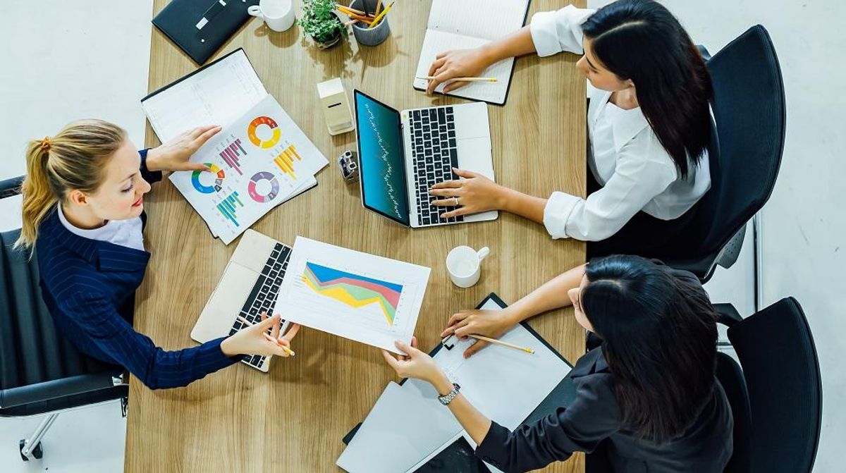 A hybrid team working on a project in the office
