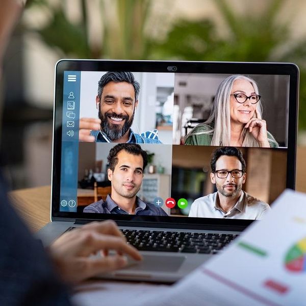 A hybrid workplace with employees on a video conference call