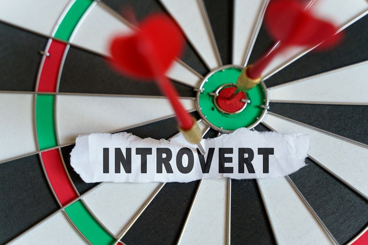 A piece of paper with the text is nailed to the target with a dart