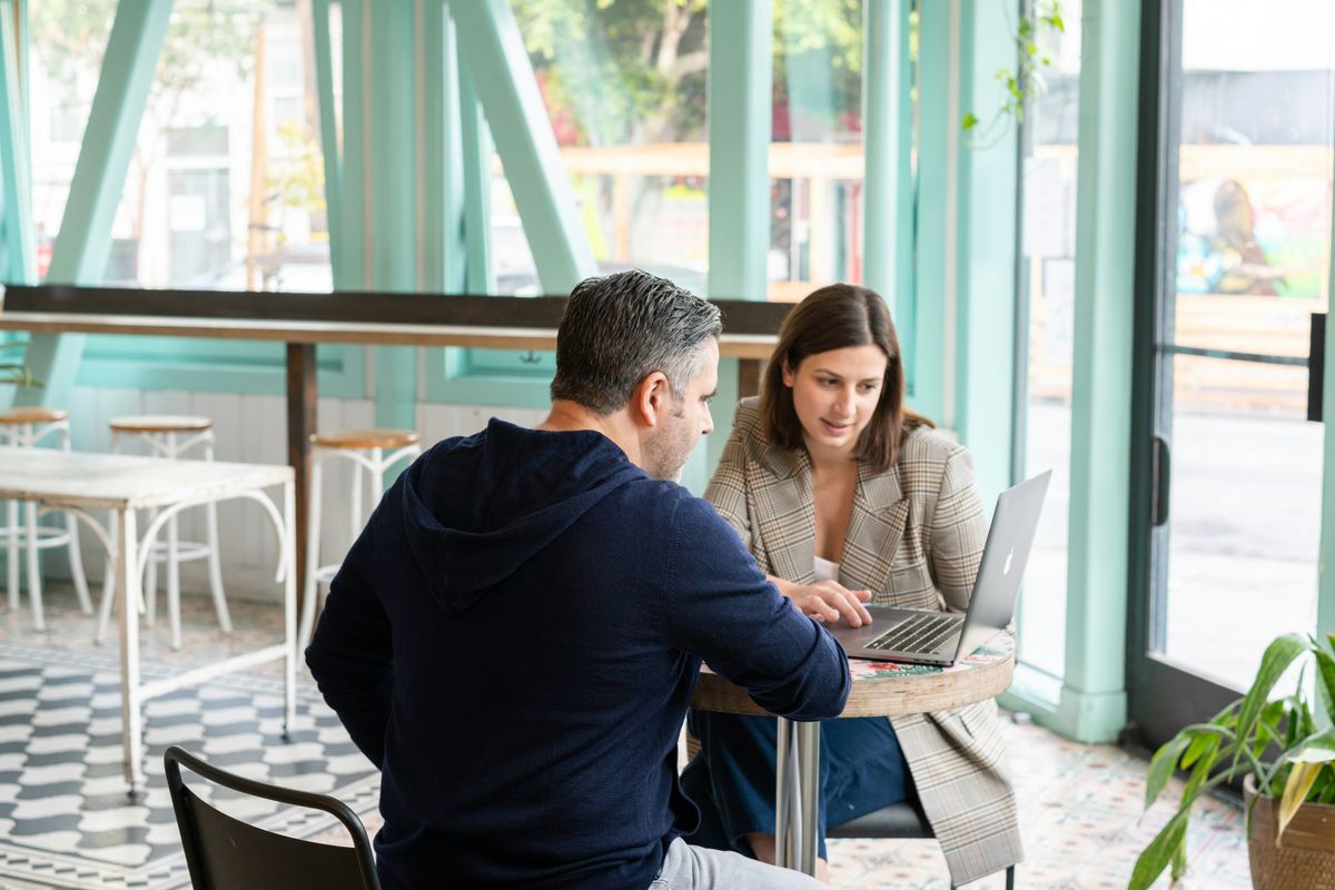 A sales person explains a software tool to a potential customer