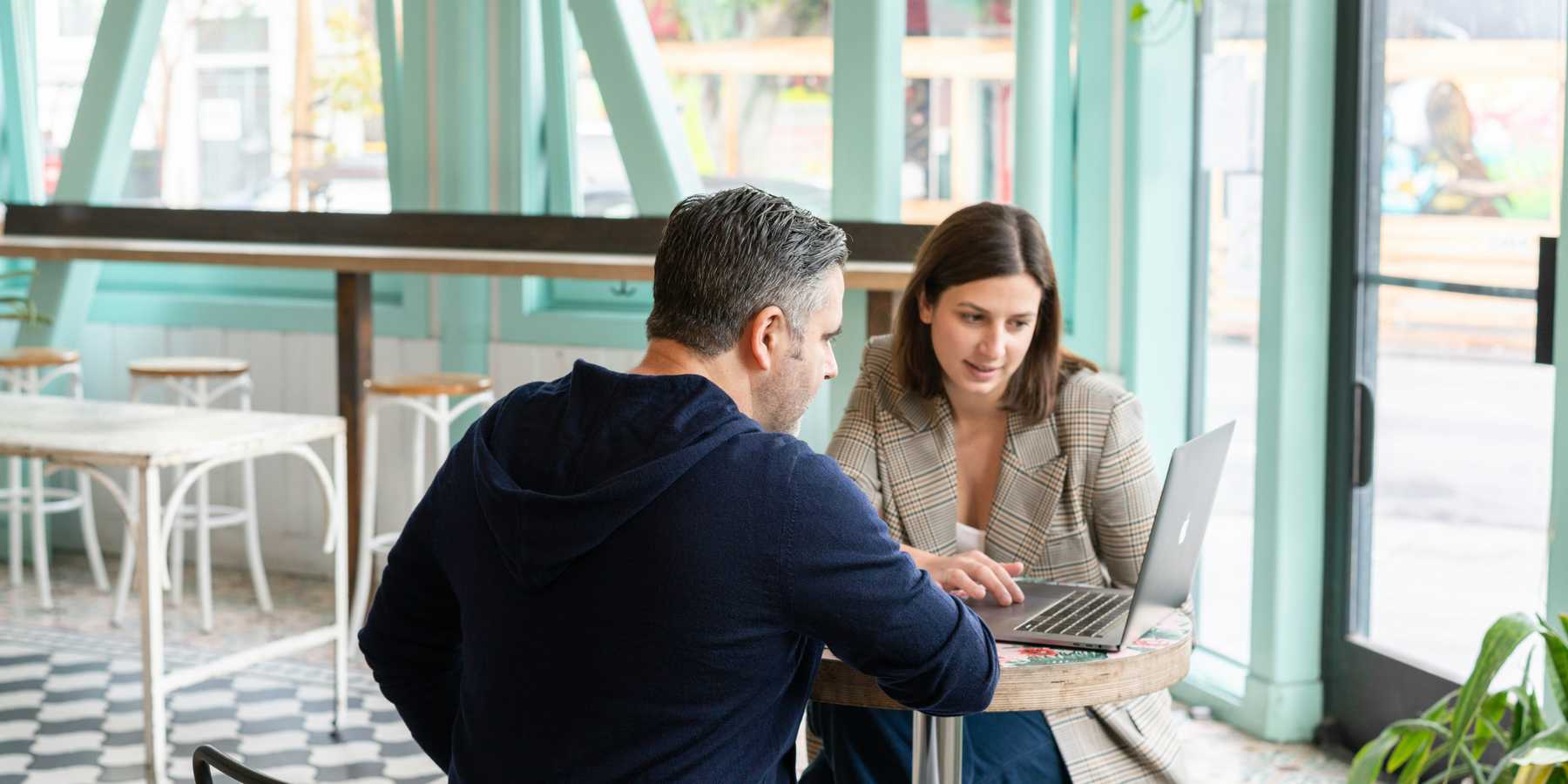 A sales person explains a software tool to a potential customer