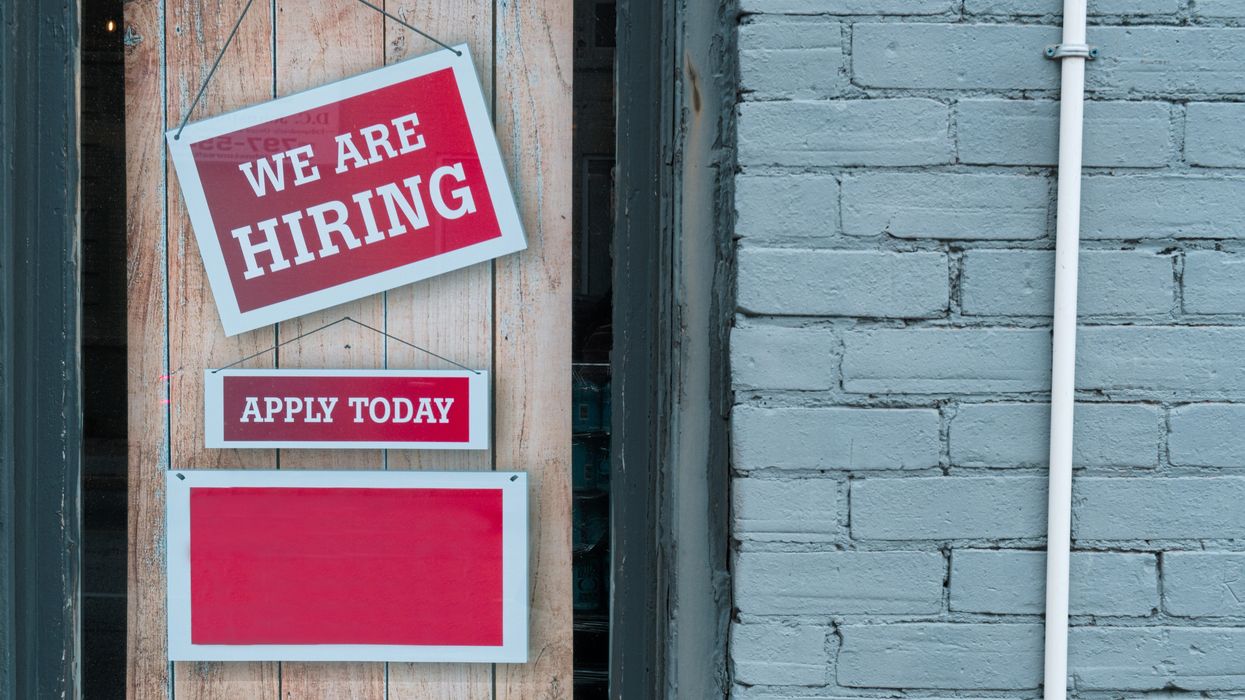 A sign on a small business hiring employees