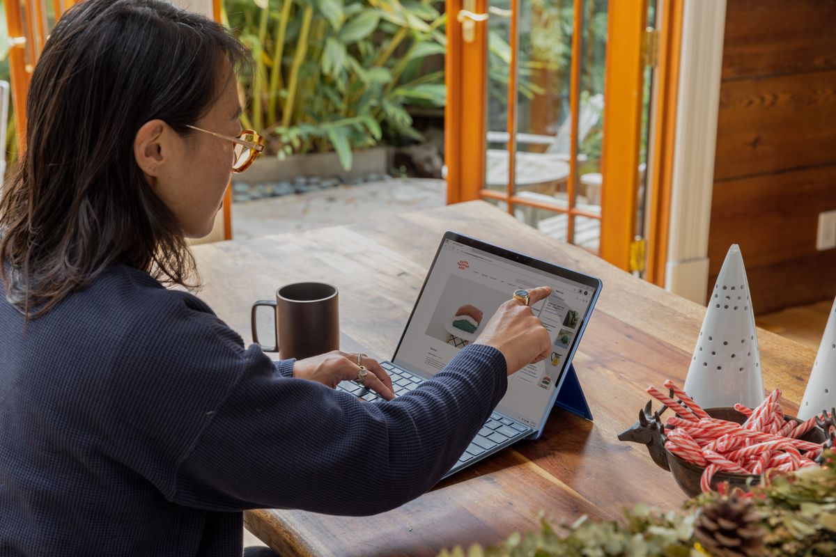 A successful woman solopreneur works on her tablet