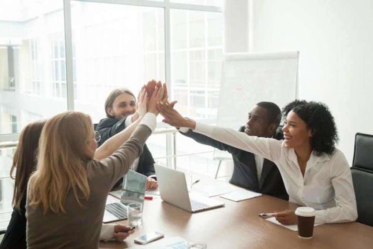 A team celebrates a successful collaboration