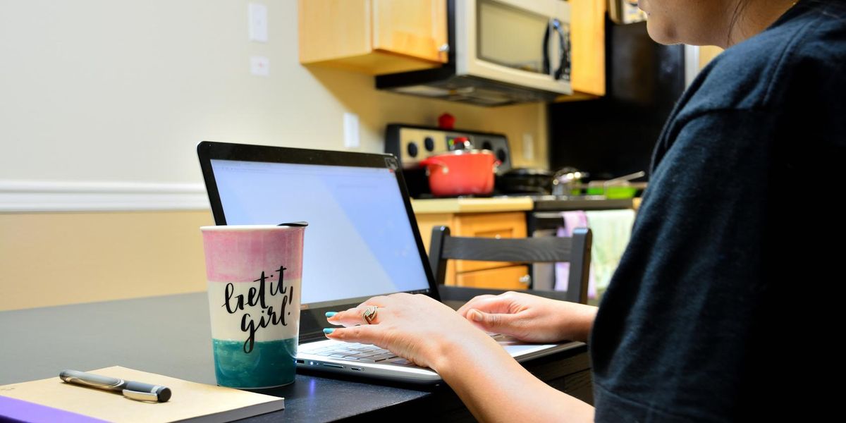 A woman working from home to start her side hustle