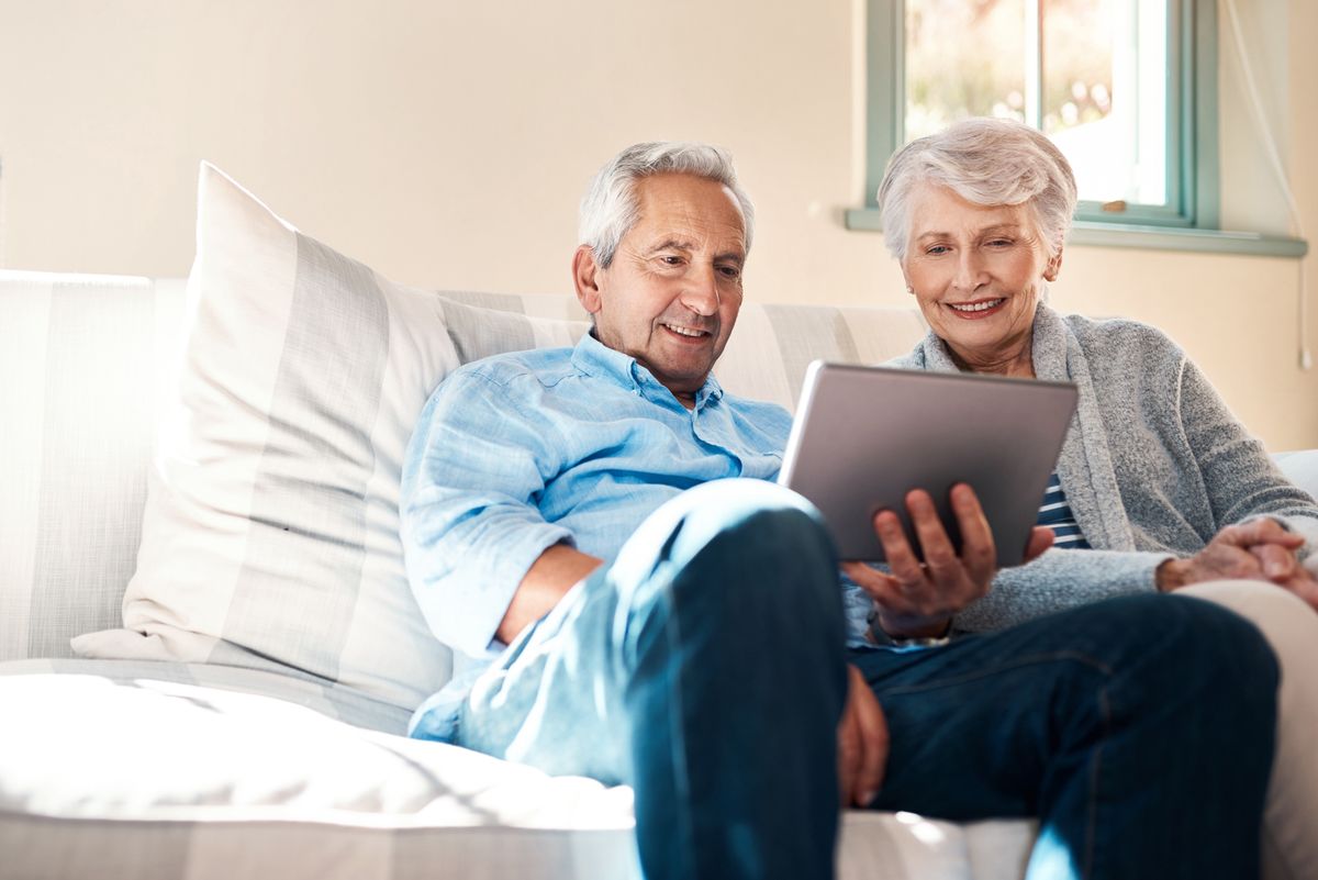 Baby boomer couple viewing marketing content on a tablet