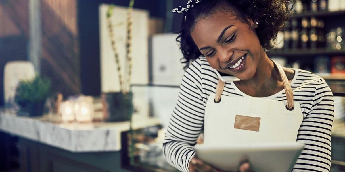 Black small business owner doing marketing tasks