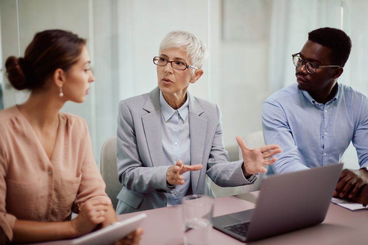 Business leader holds a meeting to lead employees through change in leadership
