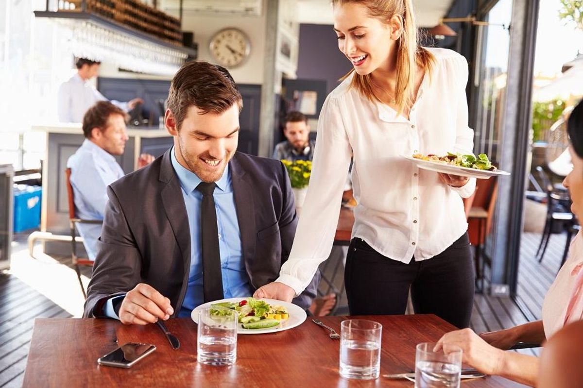 Business man being served food in a restaurant