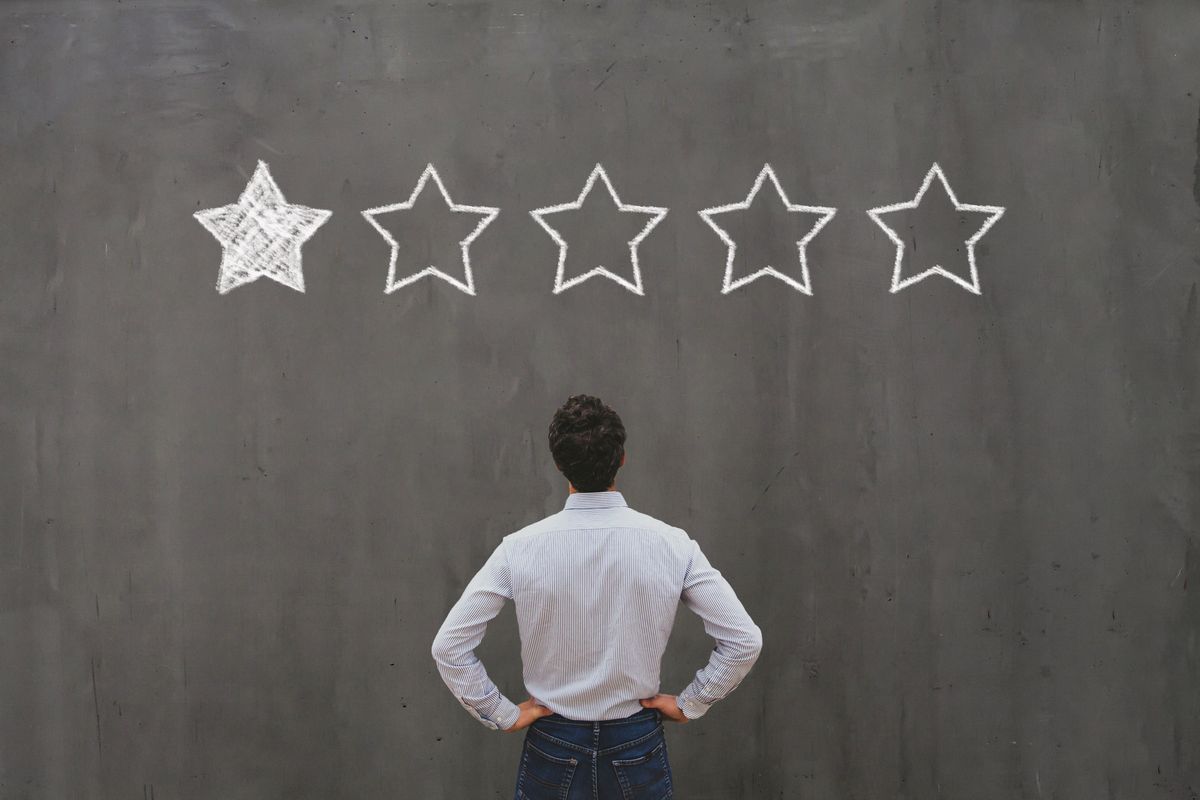 Business owner looking at negative one-star review