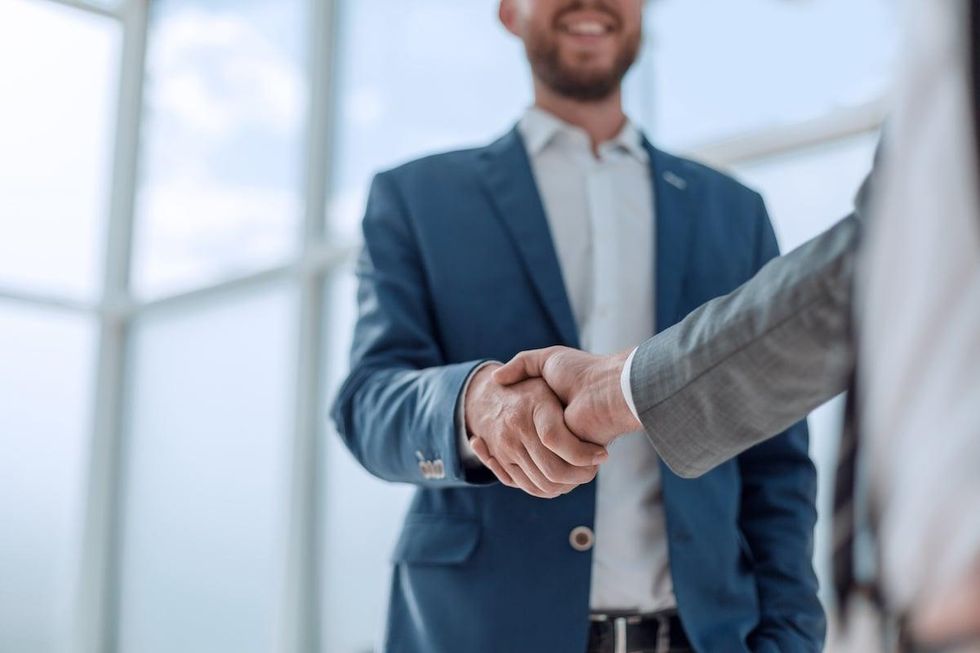 Business partners shaking hands over a decision