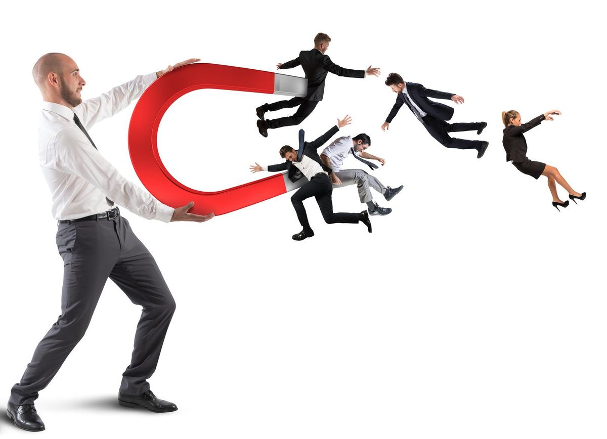 Businessman attracts people with magnet