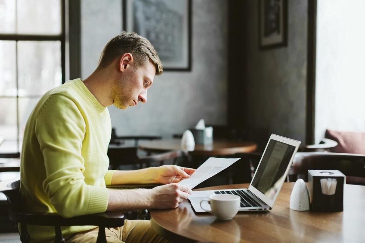 Businessman depositing payments using Quickbooks