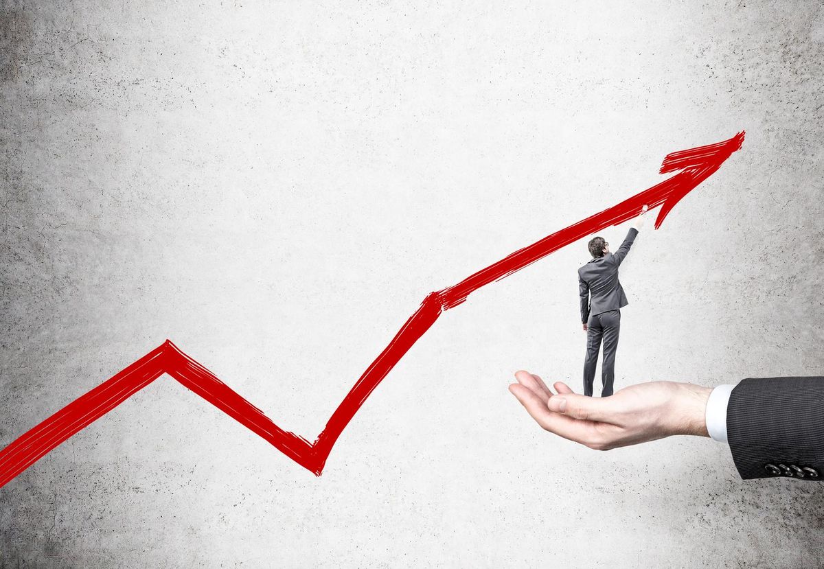 Businessman drawing chart arrow