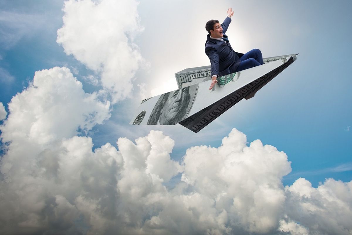 Businessman flying on paper plane in business concept