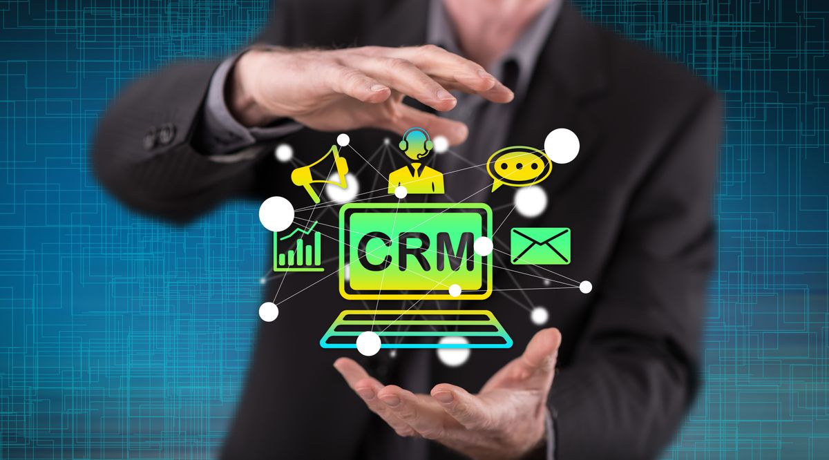 Businessman holding icons symbolizing a CRM
