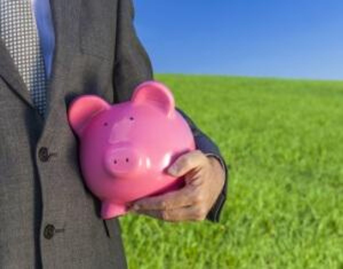 Businessman Holding Piggy Bank