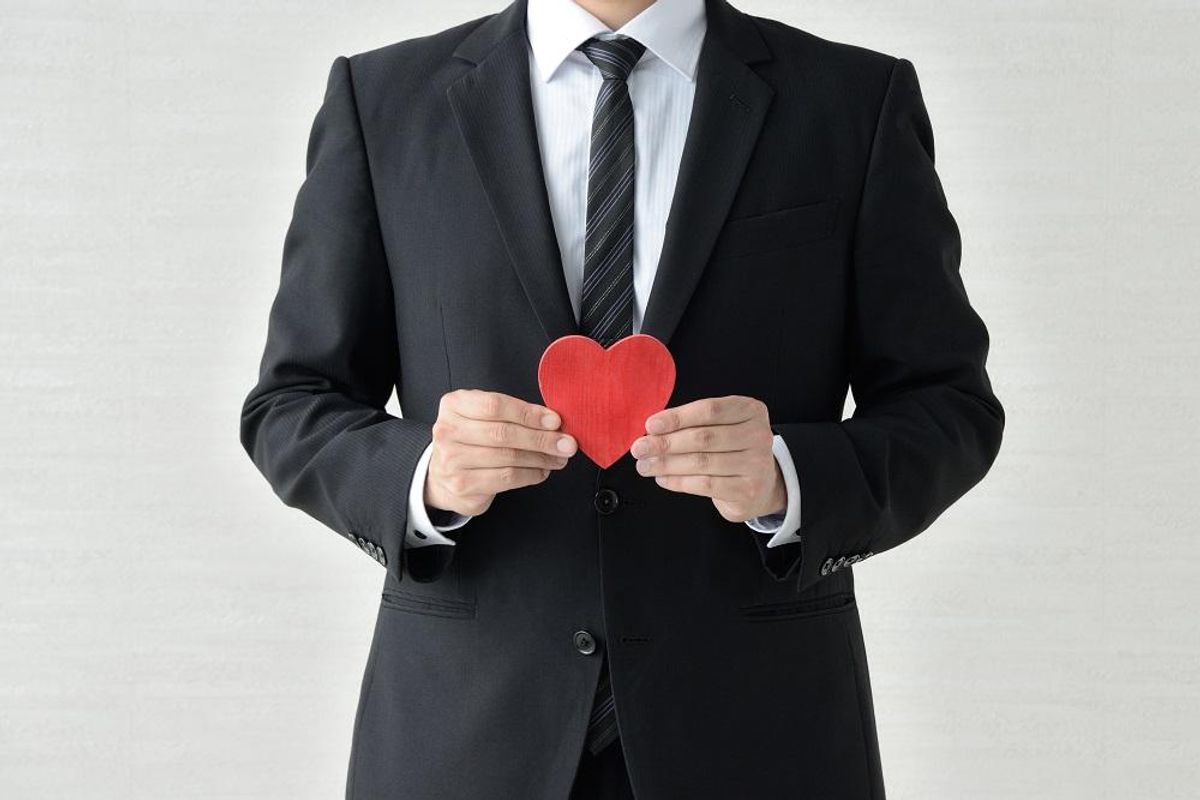 Businessman holding red heart
