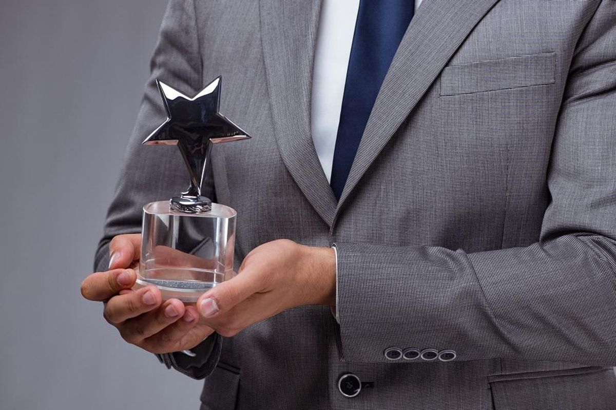 Businessman holding star award