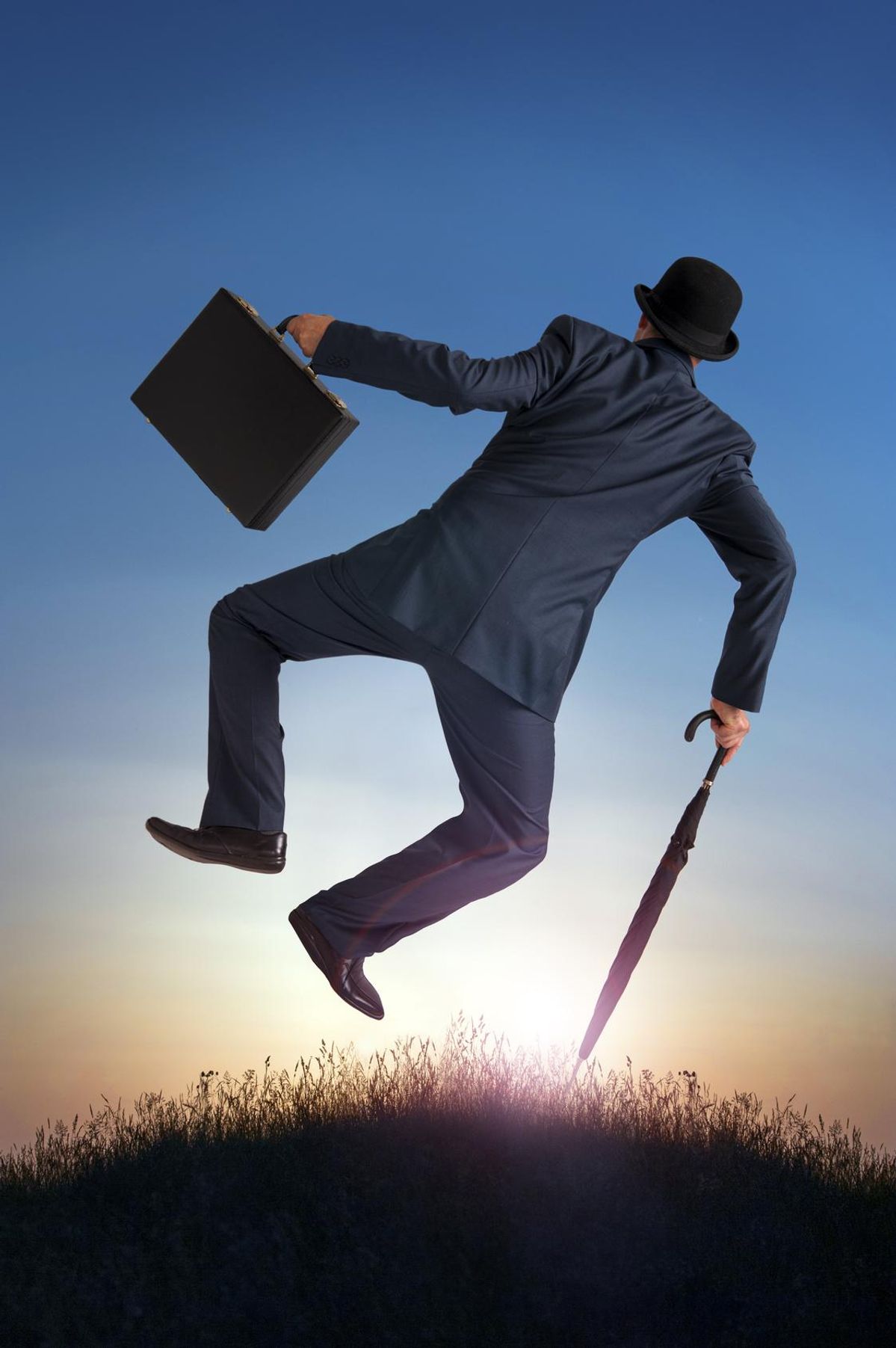 businessman kicking heels in the air