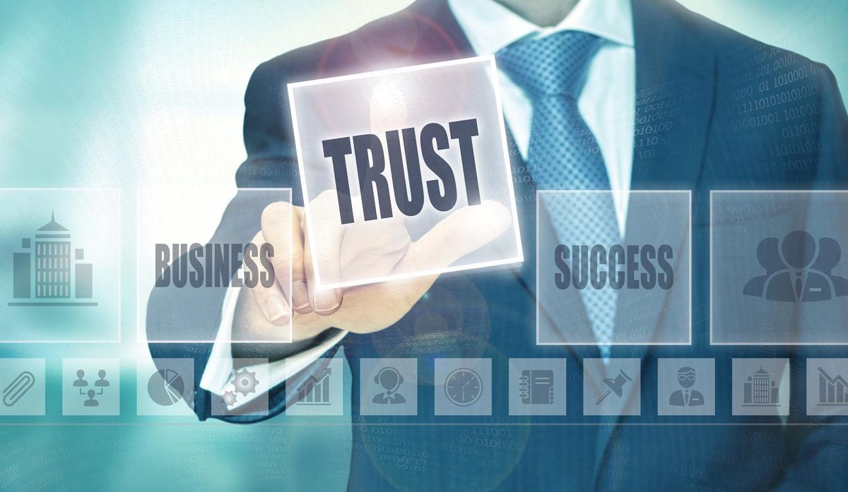 Businessman pressing a trust button