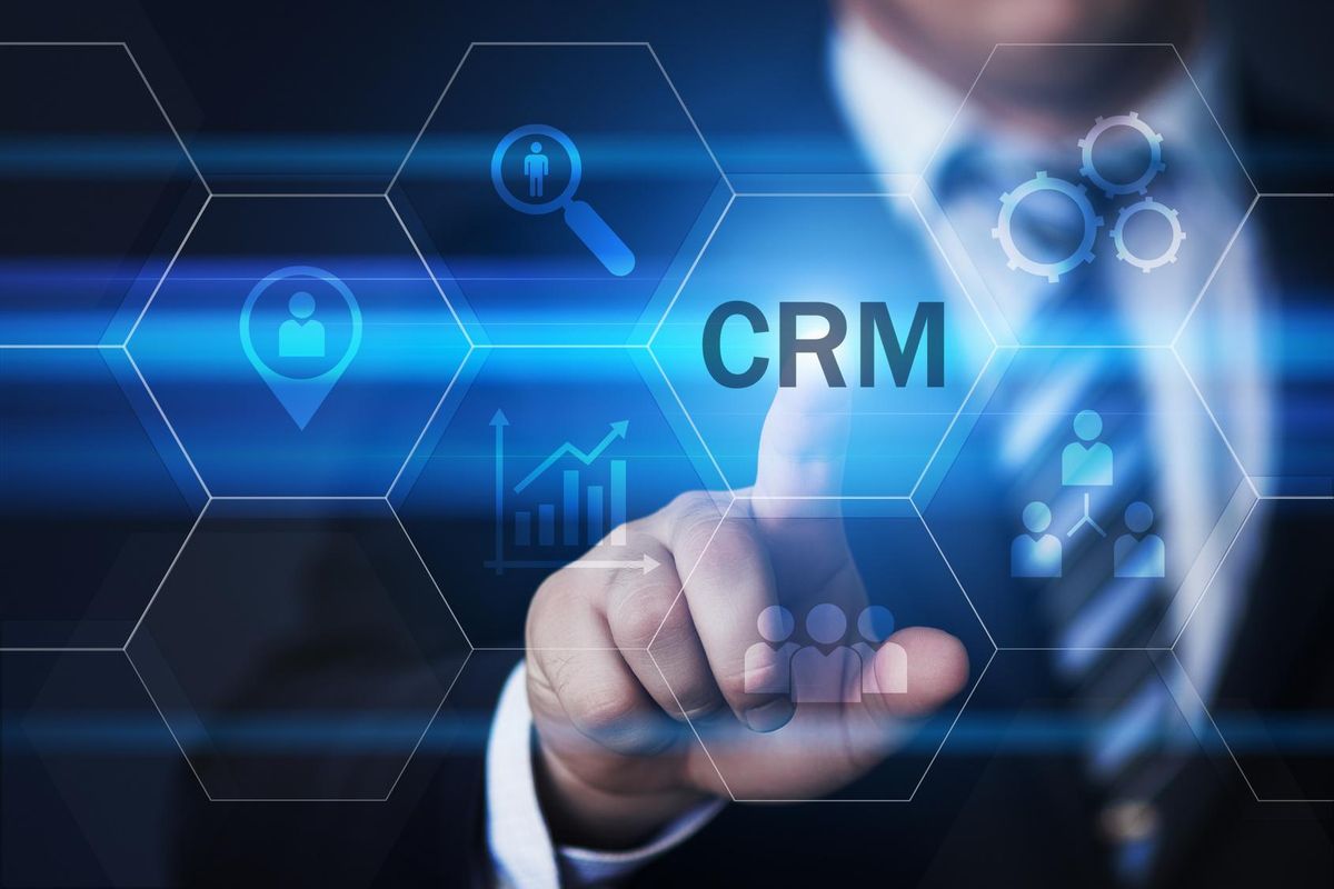 businessman pressing CRM button on virtual screens