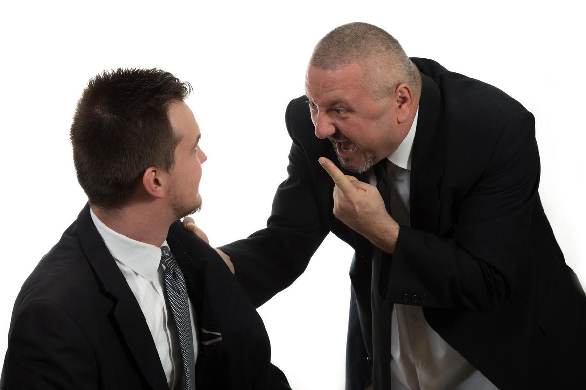 Businessman screaming at colleague