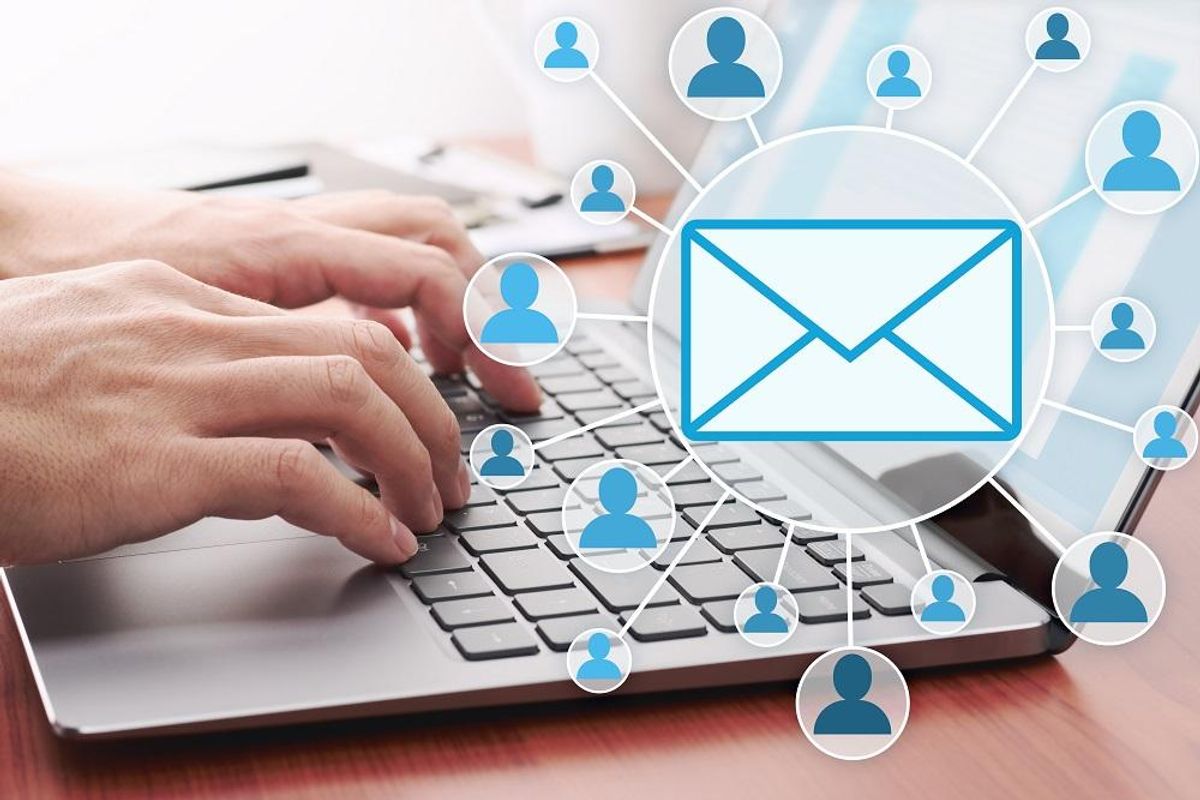 Businessman sending email by laptop