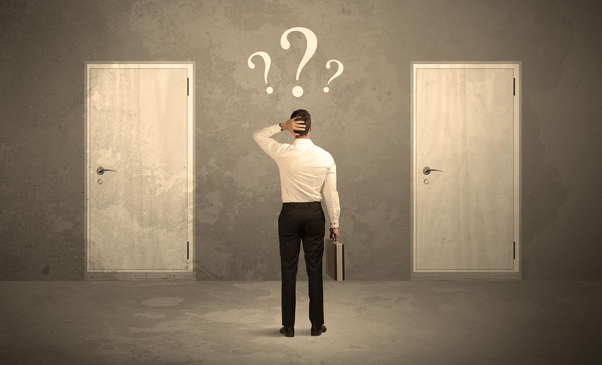 Businessman standing in front of doors