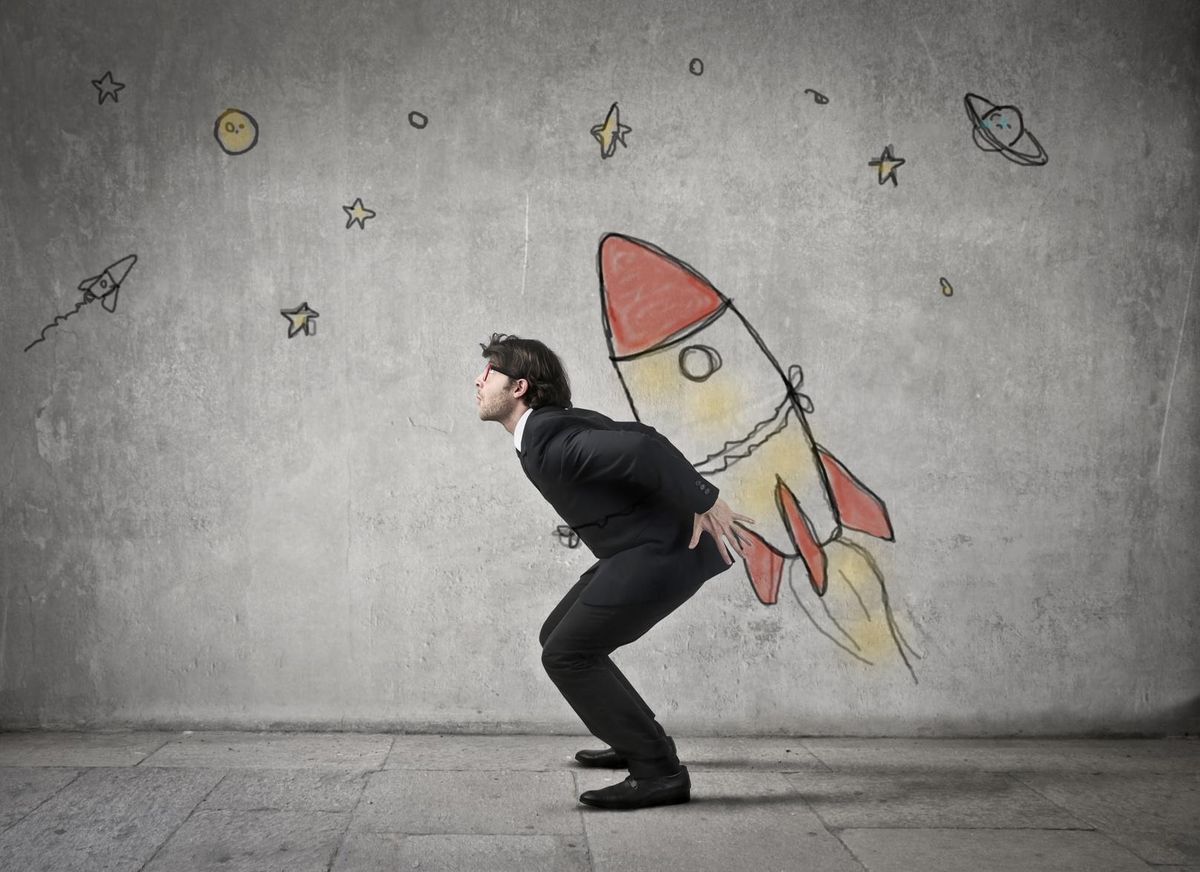 businessman strapped to rocket