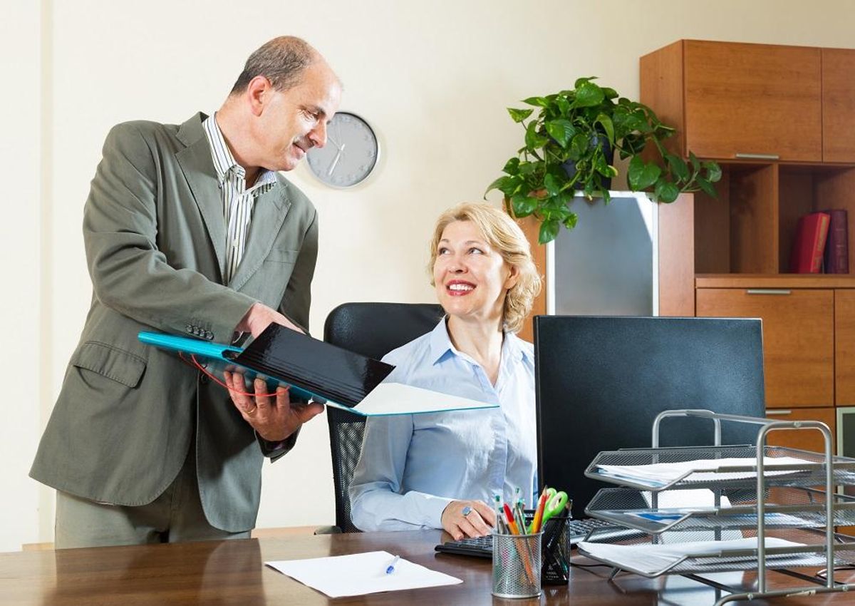 Businessman talking with secretary