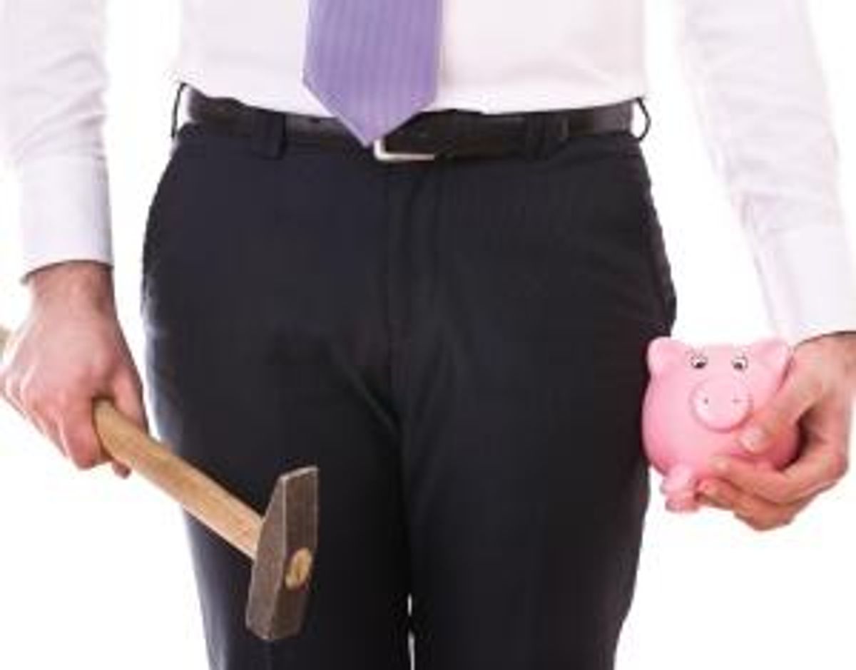 Businessman with piggy bank and hammer.