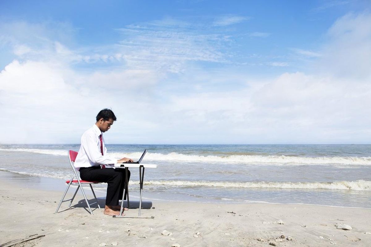 Businessman working at beach