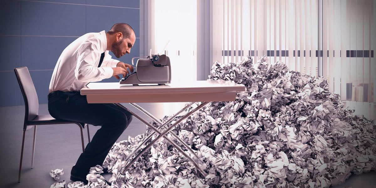 Businessman writing many drafts of a grant