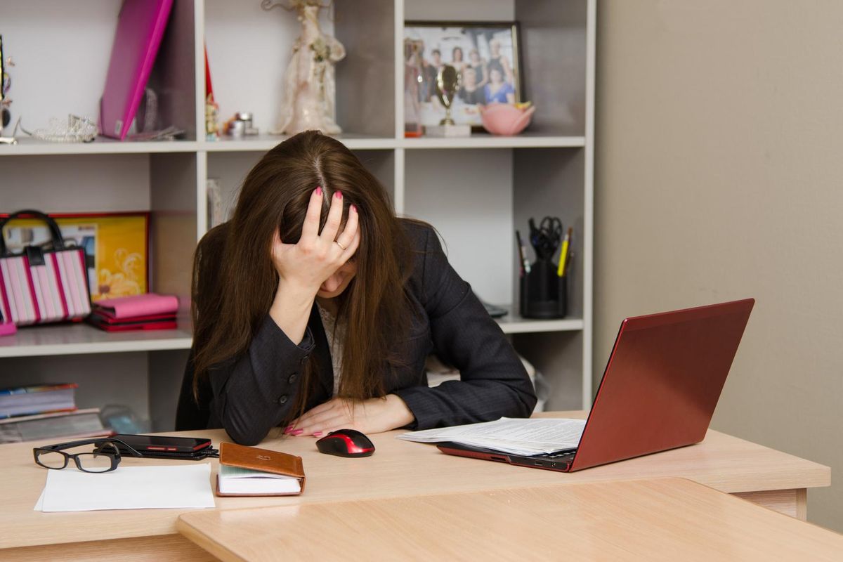 Businesswoman clutching her head