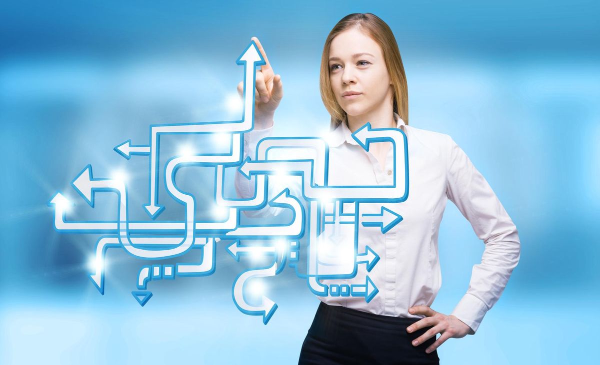Businesswoman pointing at arrow