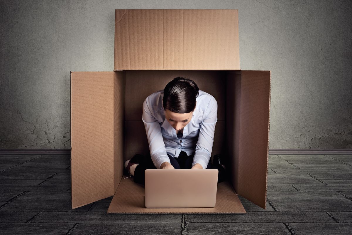 businesswoman sitting in a box representing an introvert - Business Help and Advice Introverted Businesswoman