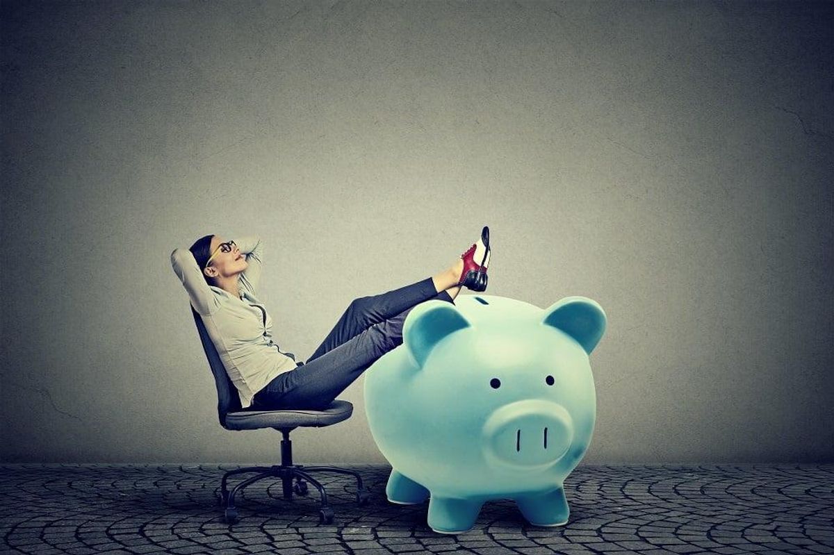 businesswoman with big piggy bank relaxing