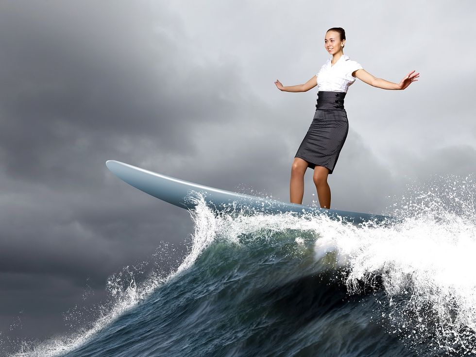busineswoman surfing and going with the flow