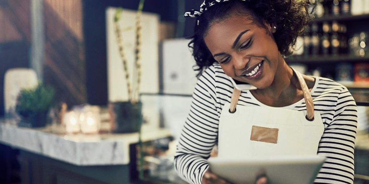 Cafe small business owner making sure she is compliant with regulations