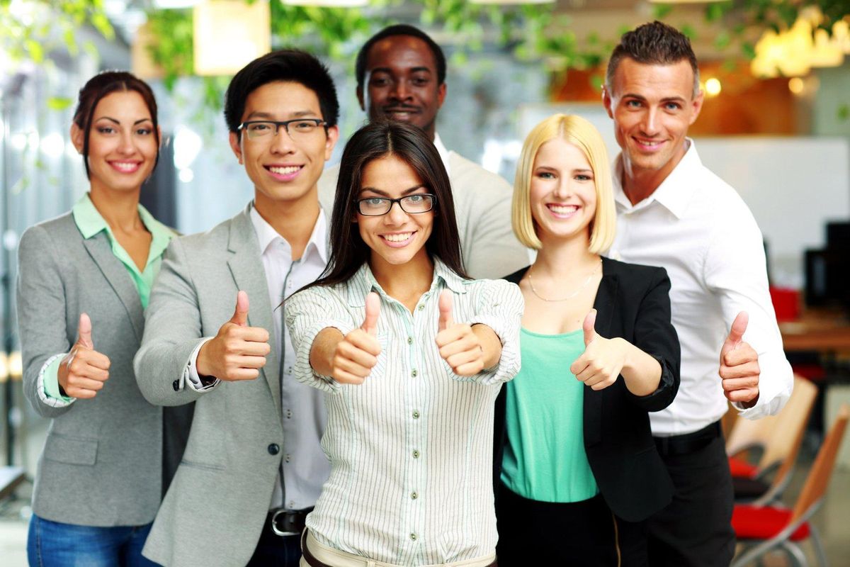 Cheerful business group giving thumbs up