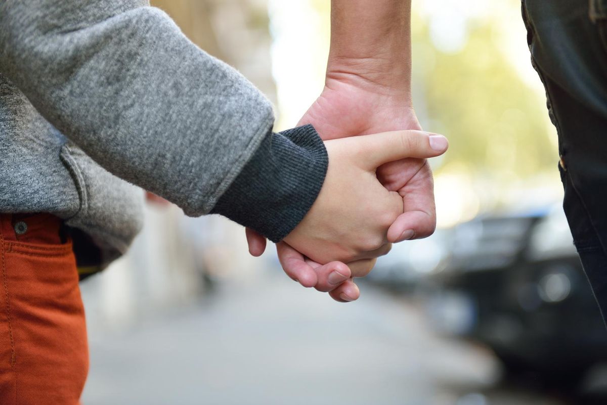 Child holding mother's hand
