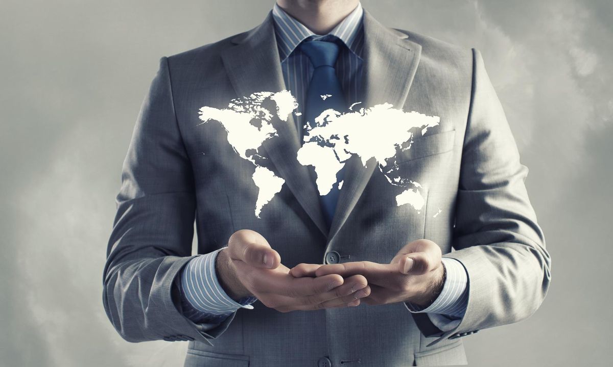 Close up of businessman holding world map in hands