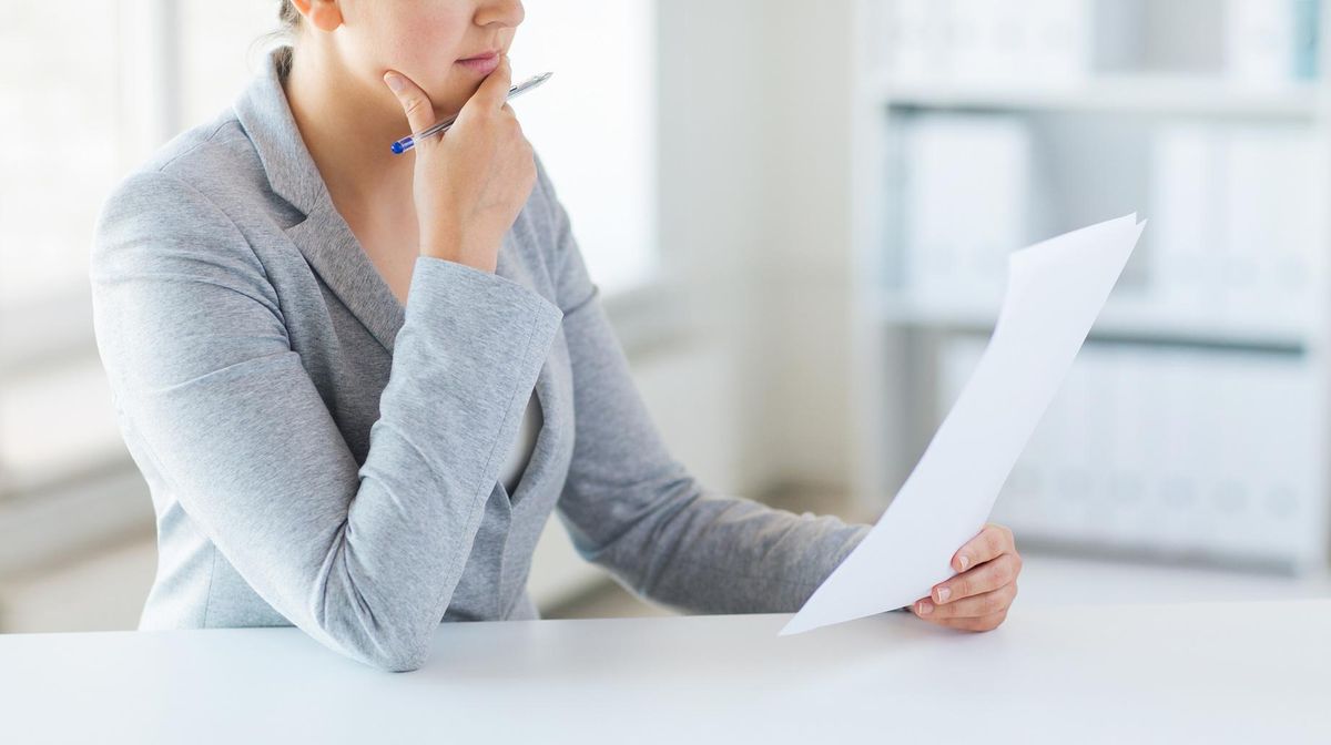 close up of woman reading papers