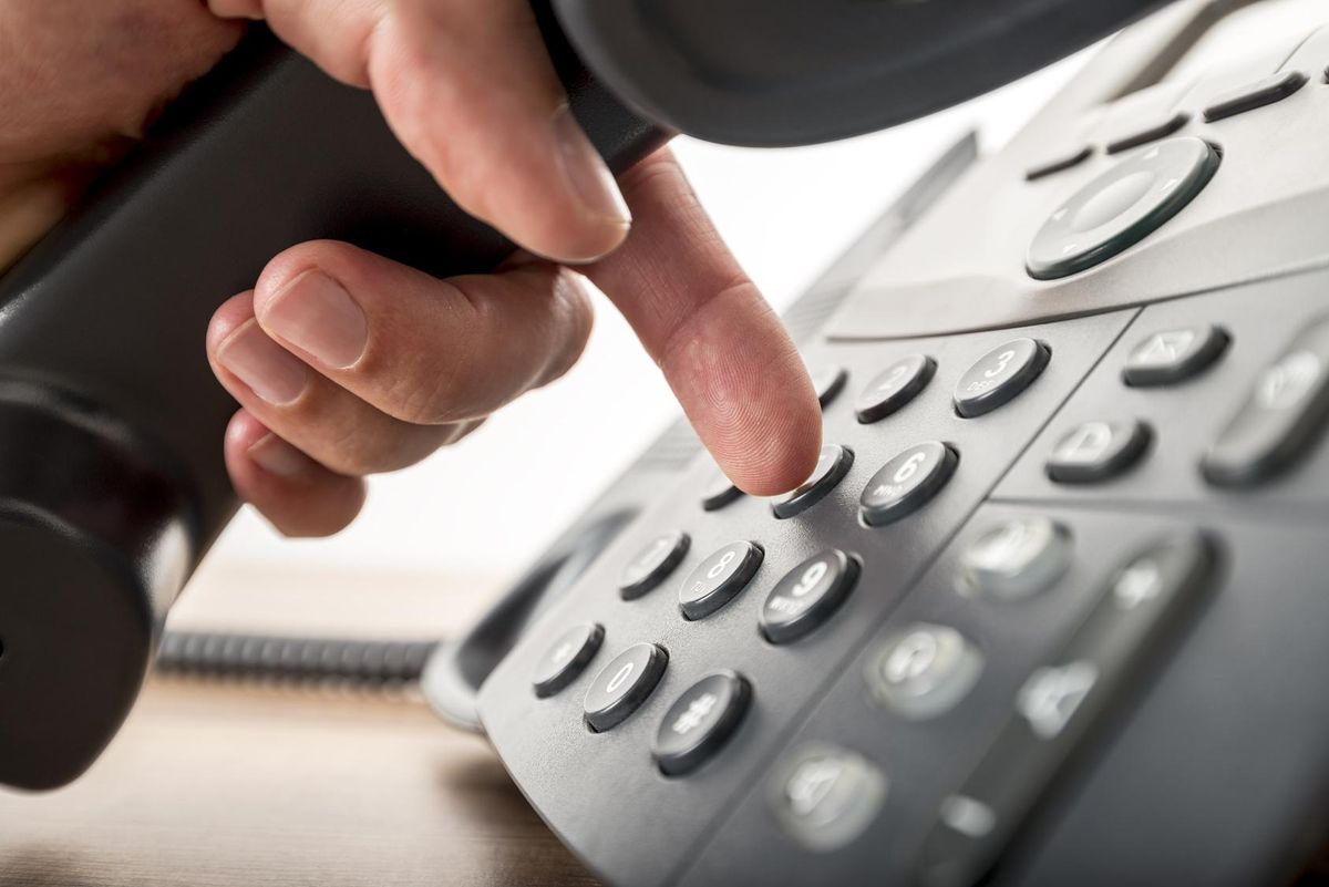 Closeup of dialing a number on a landline telephone
