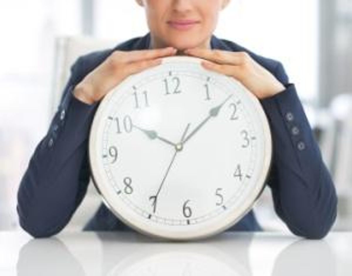 Closeup on business woman with clock