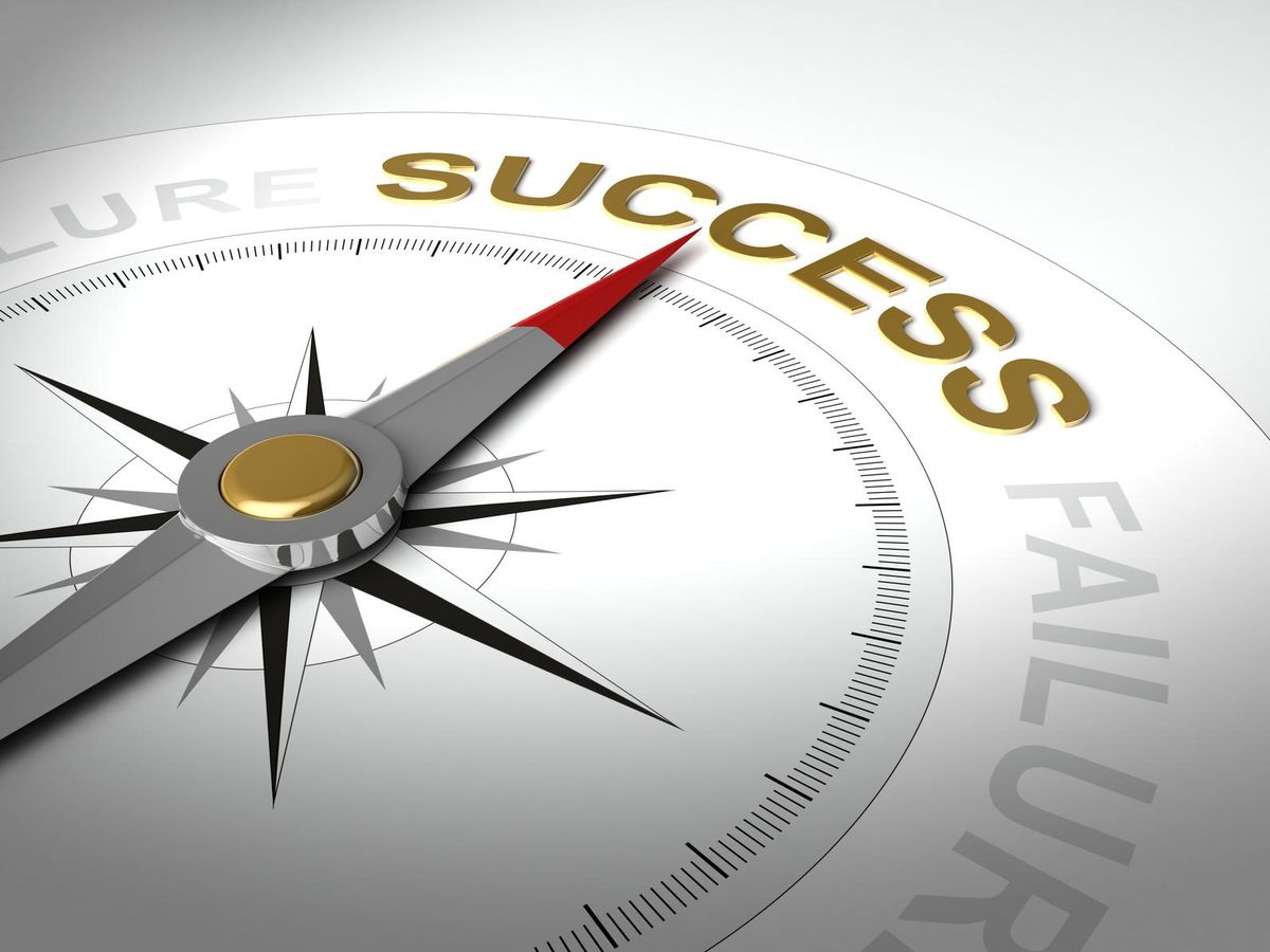 compass with needle pointing the word success