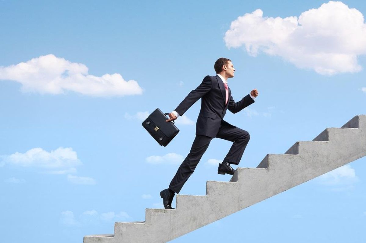 confident businessman walking upstairs